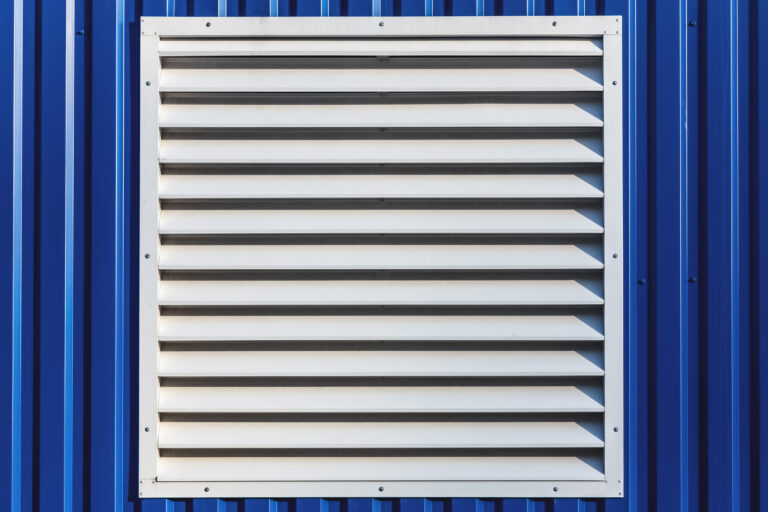 White window with jalousie in blue color metal siding wall